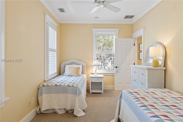 carpeted bedroom with ornamental molding and ceiling fan