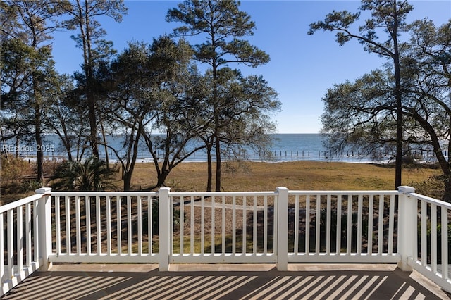 wooden terrace featuring a water view