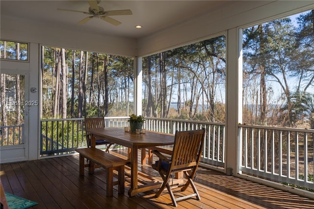 sunroom / solarium featuring ceiling fan