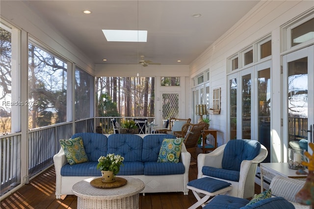 sunroom with a skylight, ceiling fan, and plenty of natural light