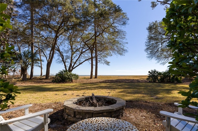 view of yard with a rural view and an outdoor fire pit