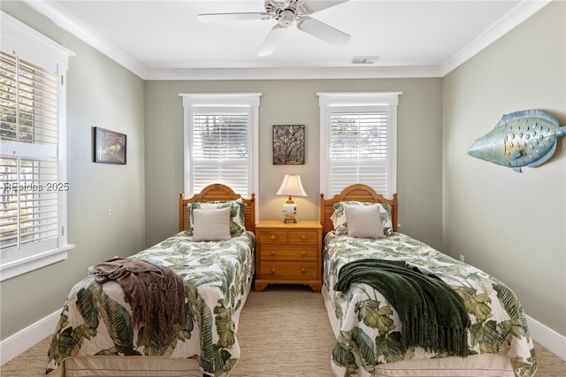 carpeted bedroom with ornamental molding and ceiling fan