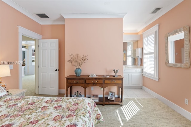 bedroom featuring ornamental molding, light tile patterned floors, and ensuite bath