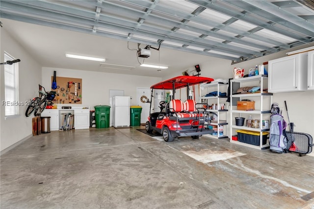 garage featuring a garage door opener and white refrigerator