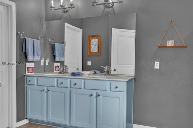 bathroom with vanity, tile patterned floors, and an inviting chandelier