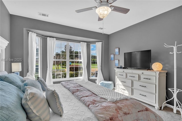 bedroom featuring light carpet and ceiling fan