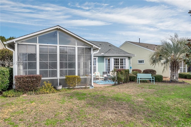 back of house with a patio and a lawn