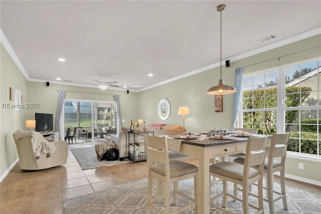 dining space with ceiling fan, crown molding, light tile patterned floors, and a healthy amount of sunlight