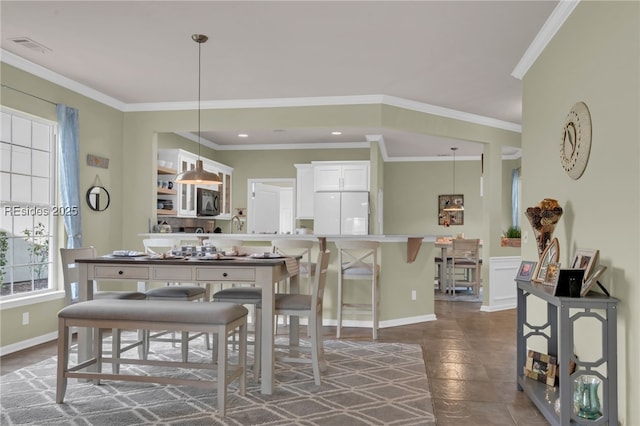 tiled dining room with crown molding