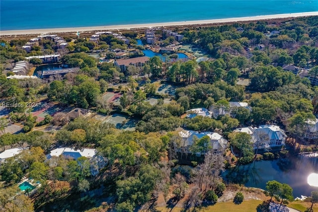 birds eye view of property featuring a beach view and a water view