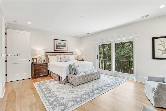 bedroom featuring light hardwood / wood-style floors and access to outside