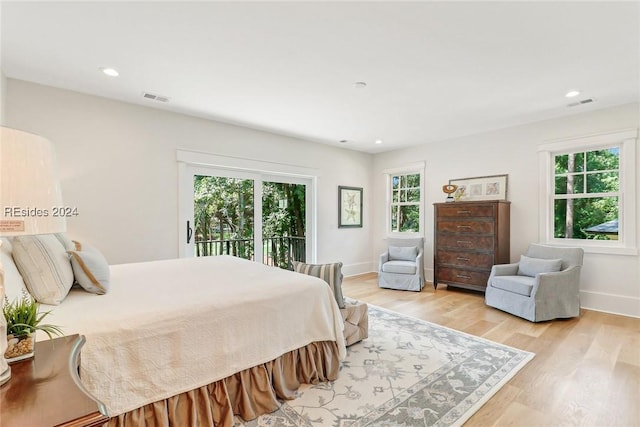 bedroom featuring light hardwood / wood-style flooring and access to outside