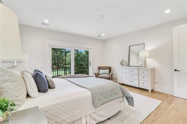 bedroom featuring access to exterior and light hardwood / wood-style flooring