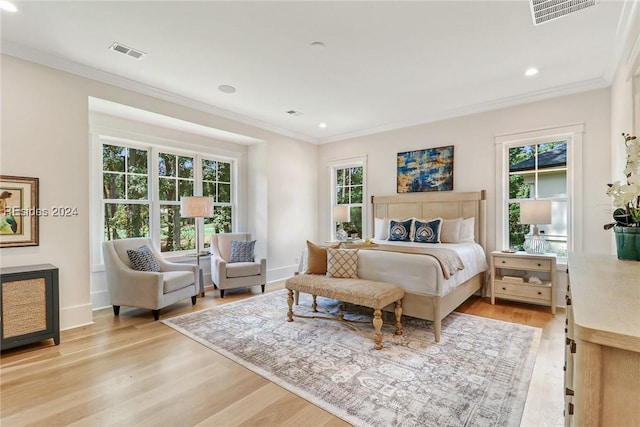 bedroom with light hardwood / wood-style flooring and ornamental molding