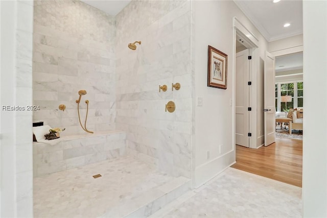 bathroom featuring hardwood / wood-style flooring, crown molding, and tiled shower