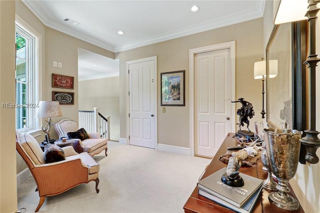 sitting room featuring ornamental molding and light carpet