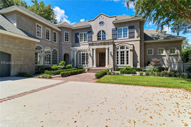 mediterranean / spanish-style house with a front yard