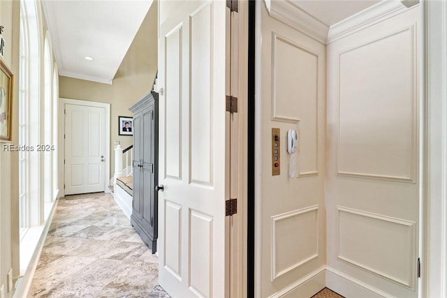 corridor with crown molding and elevator