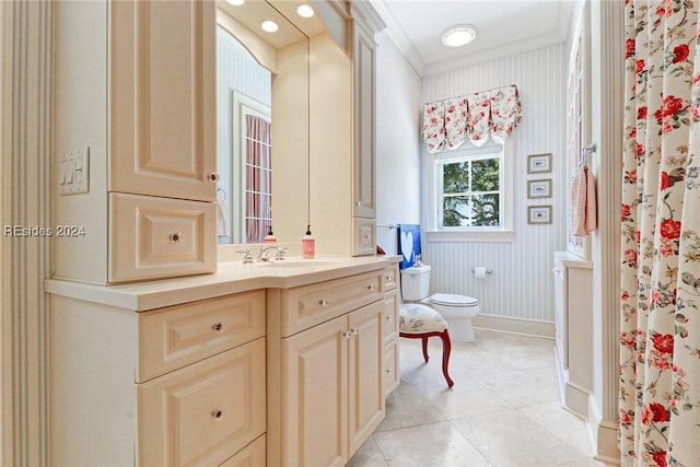 bathroom with toilet, vanity, walk in shower, crown molding, and tile patterned floors