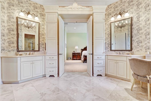 bathroom featuring crown molding, vanity, and a chandelier