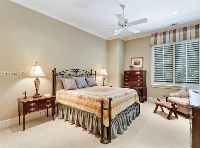 carpeted bedroom featuring ornamental molding and ceiling fan