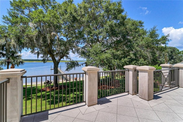 view of patio / terrace featuring a water view and a balcony