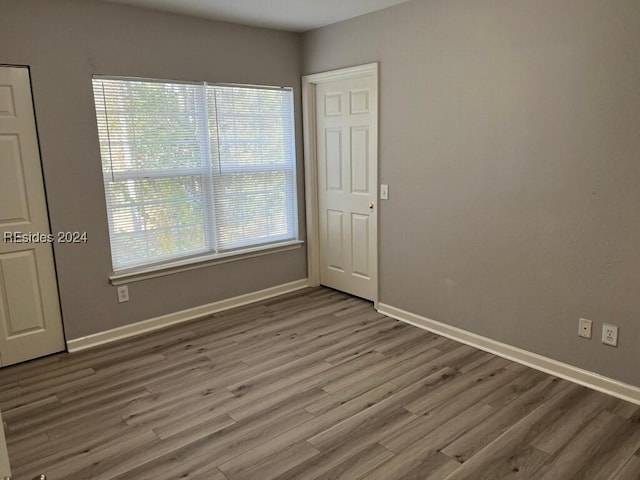 unfurnished room featuring hardwood / wood-style flooring