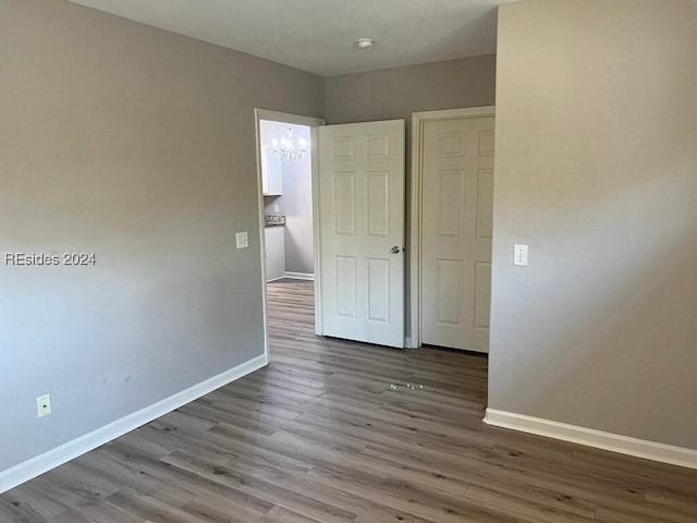 interior space featuring hardwood / wood-style flooring and a chandelier