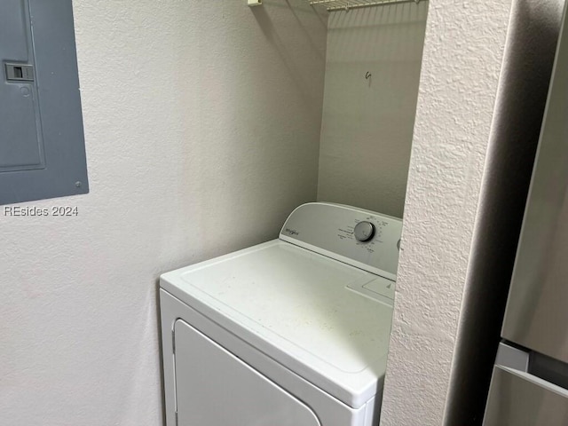 laundry room featuring electric panel and washer / dryer