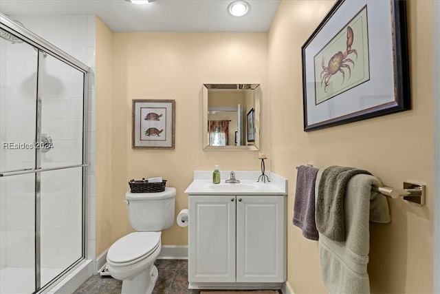 bathroom with vanity, an enclosed shower, and toilet