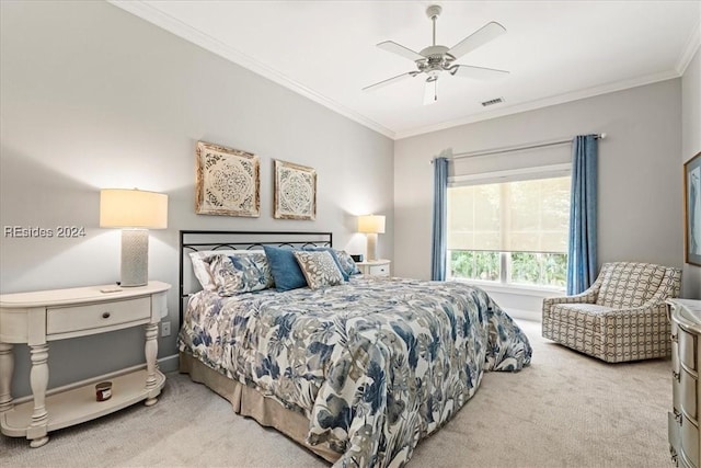 carpeted bedroom featuring ceiling fan and ornamental molding