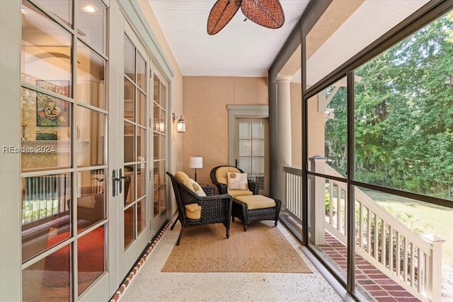 sunroom / solarium with ceiling fan and french doors