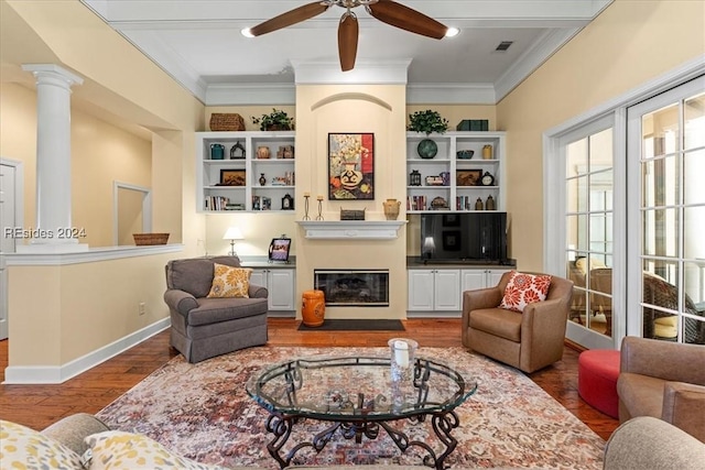 living room with hardwood / wood-style floors, ornamental molding, decorative columns, and ceiling fan