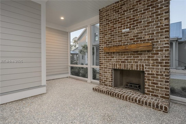 unfurnished living room with a fireplace and wood walls