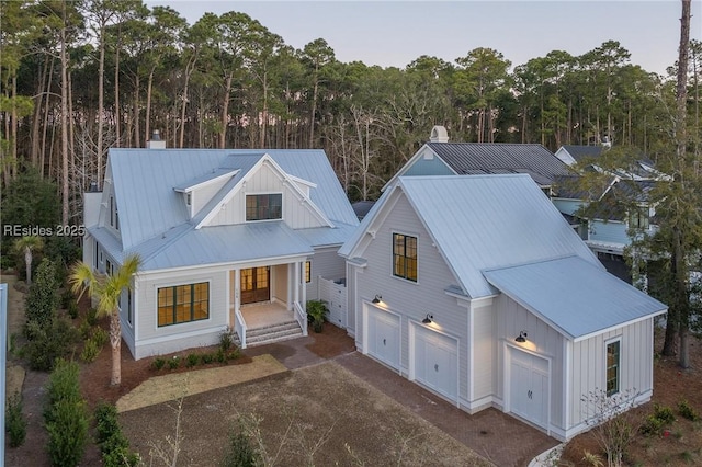 modern inspired farmhouse with a garage and covered porch