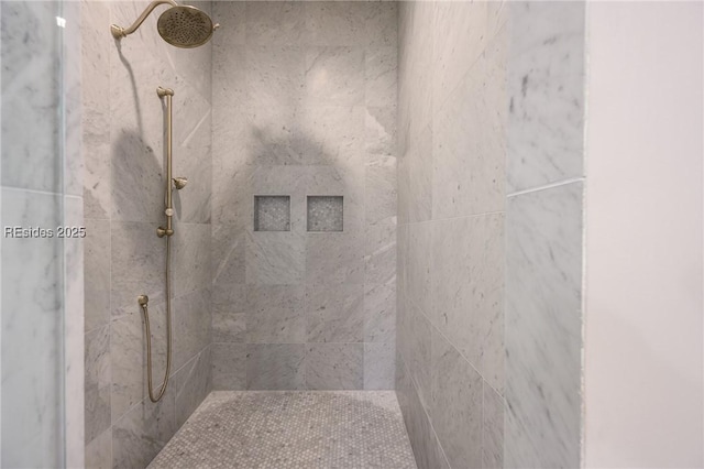 bathroom with a tile shower