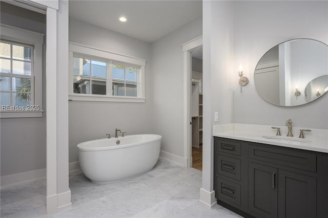 bathroom featuring vanity and a bath