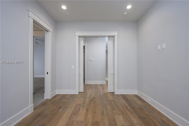 corridor featuring hardwood / wood-style floors