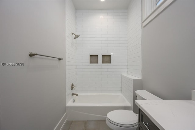 full bathroom featuring tiled shower / bath, vanity, toilet, and tile patterned flooring