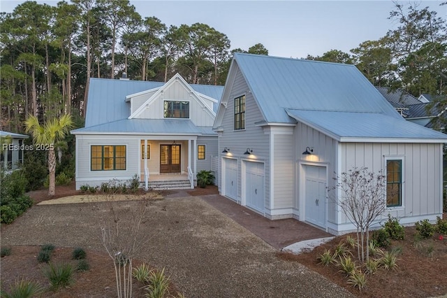 modern farmhouse style home with a garage and covered porch