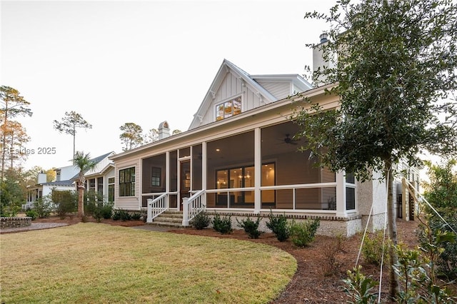 view of front facade featuring ceiling fan, a front yard, and a sunroom