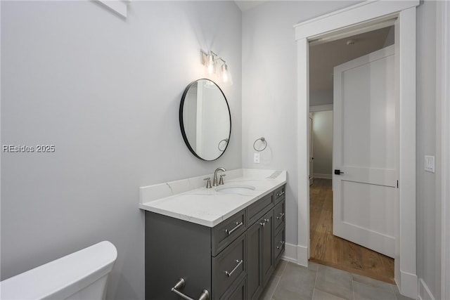 bathroom with vanity, tile patterned floors, and toilet