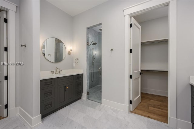 bathroom featuring vanity and a shower with shower door