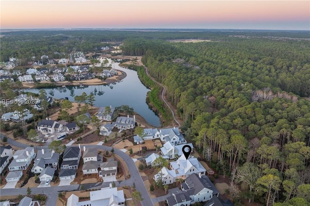 aerial view at dusk with a water view