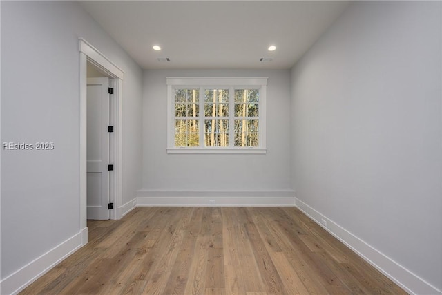 spare room with light hardwood / wood-style flooring