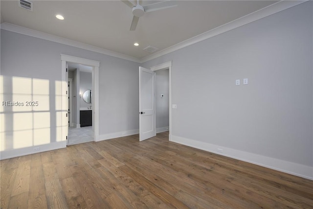 spare room with ceiling fan, ornamental molding, and wood-type flooring