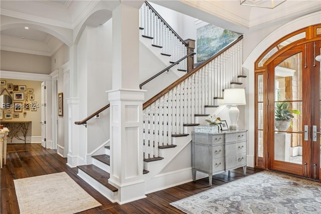 staircase with french doors, ornamental molding, and wood-type flooring