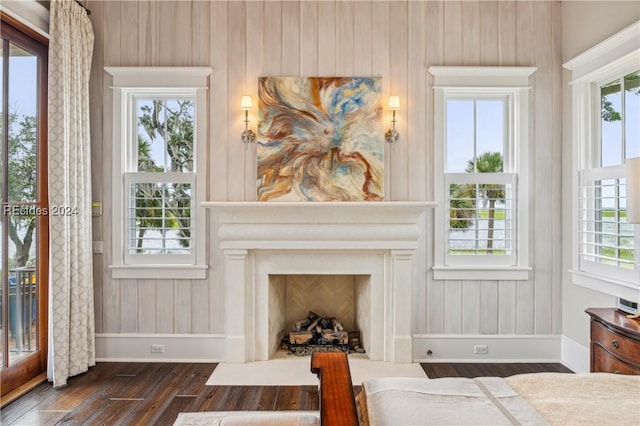 bedroom featuring dark hardwood / wood-style flooring and a high end fireplace