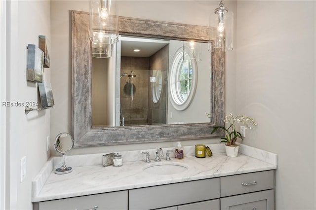 bathroom featuring vanity and an enclosed shower