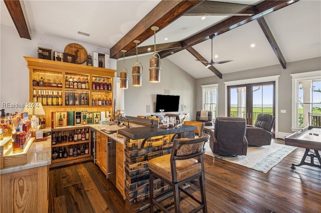 bar with dark wood-type flooring, ceiling fan, high vaulted ceiling, and beamed ceiling